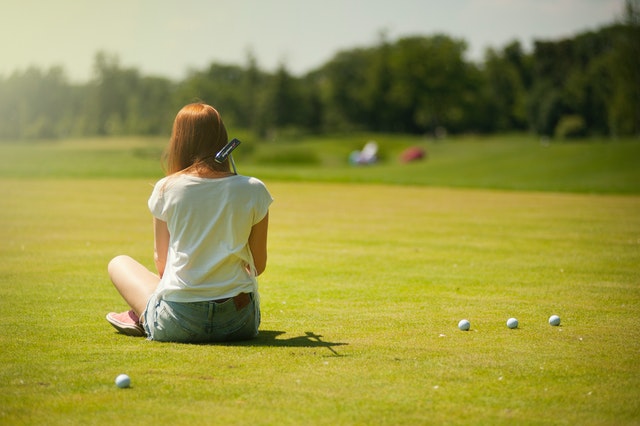 sitting on a golf course